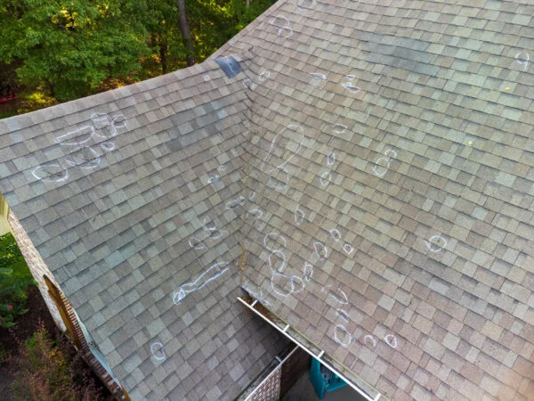 Hail Damage to a shingle roof marked by chalk.