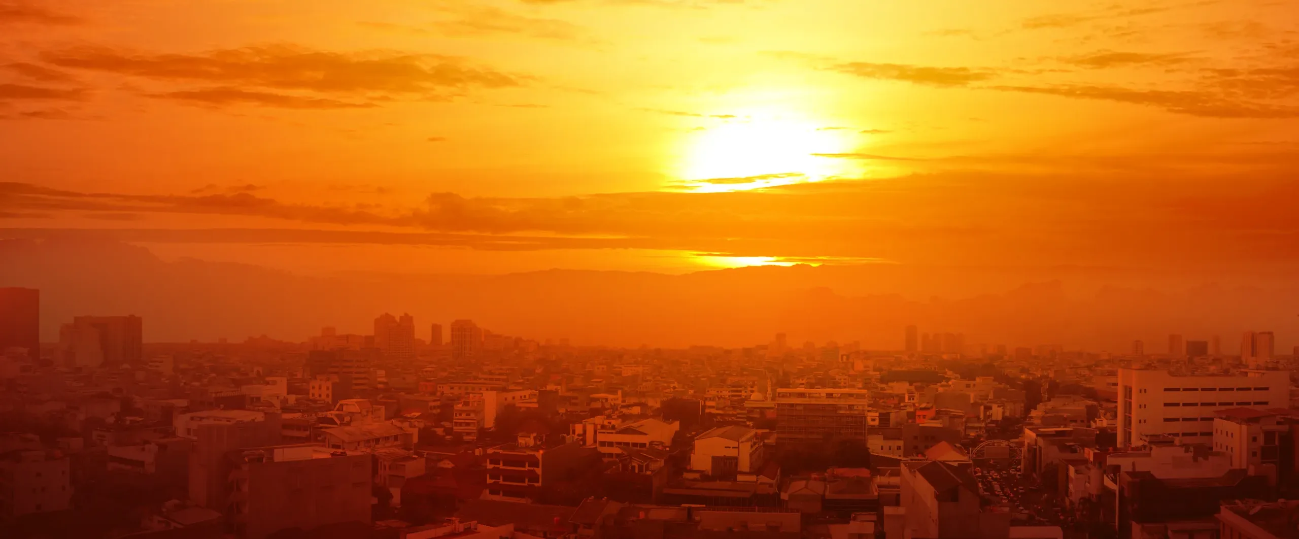 Heatwave on the city with the glowing sun background